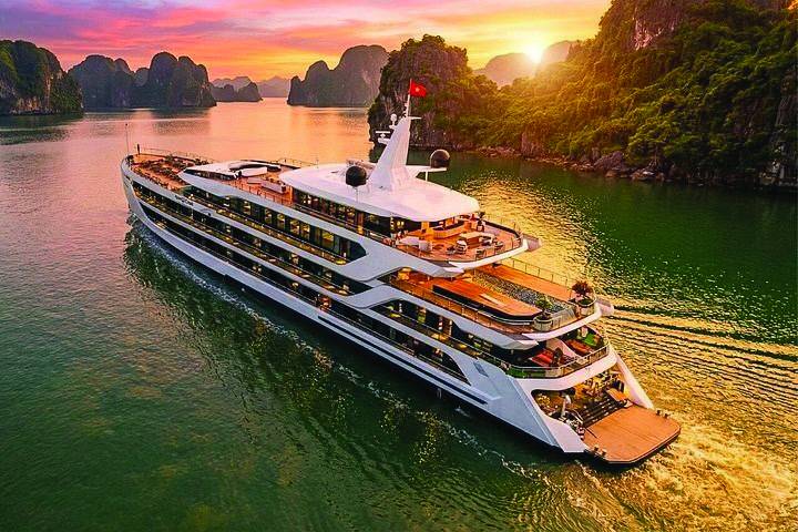 Day cruise ship on Ha Long Bay at golden hour