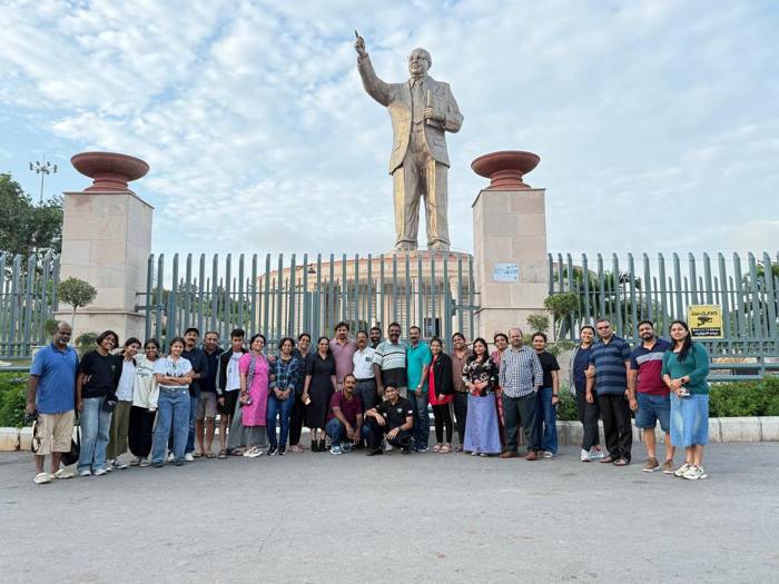 Coral Holidays group in front of a statue